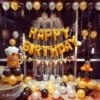 Happy Birthday Foil Letters 13 pcs- Golden + 2pcs Silver Fringe Curtains + 1pc Foil Black Bottle + 1pc Foil Cheers Mug + 30pcs Black, Gold, Silver Metallic Balloons Combo